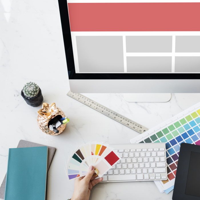 Web design workspace with monitor, colour swatches and design tools